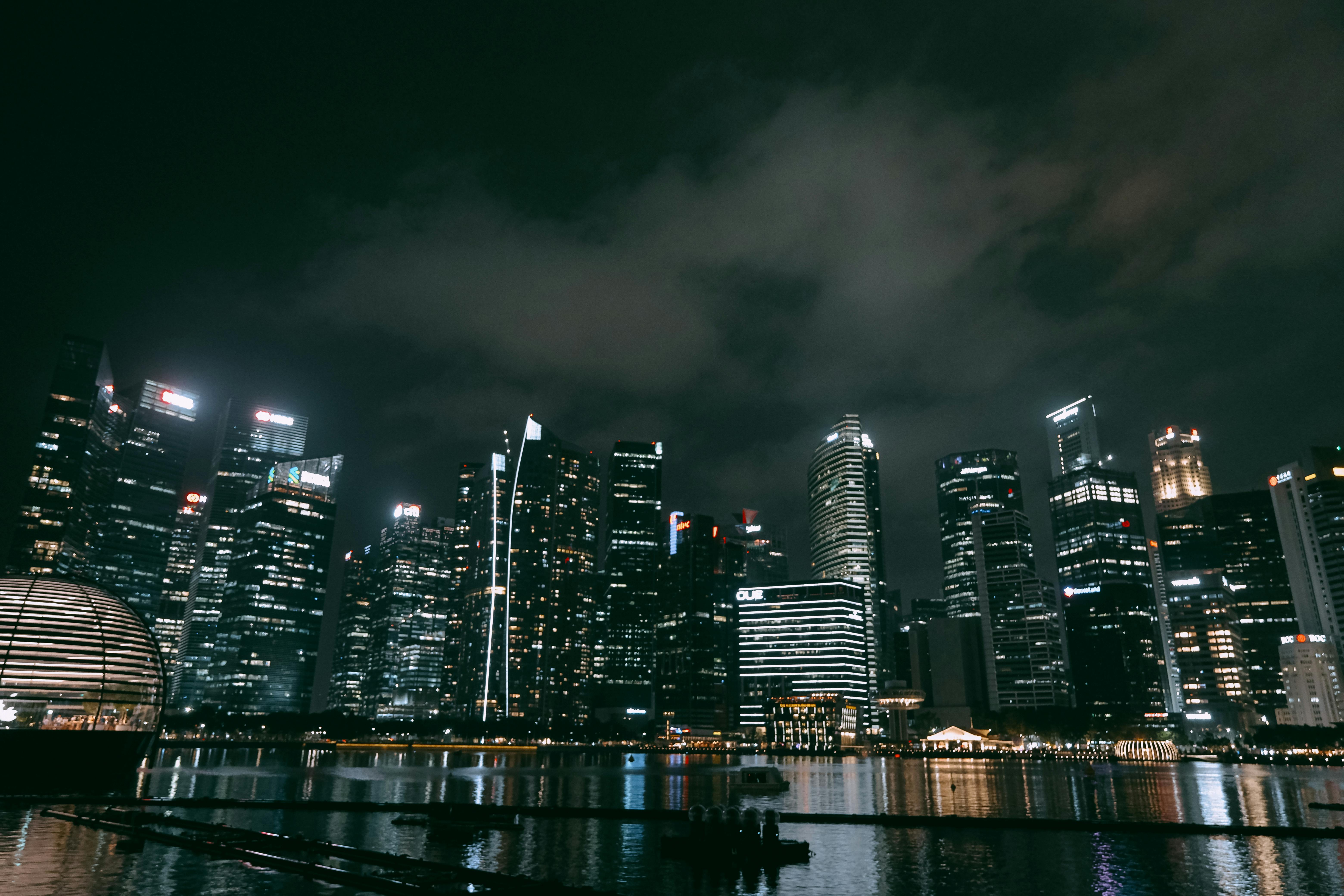 Singapore skyline illuminated at night.